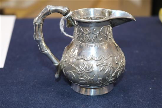 A Chinese cream jug and a small group of mixed metal items.